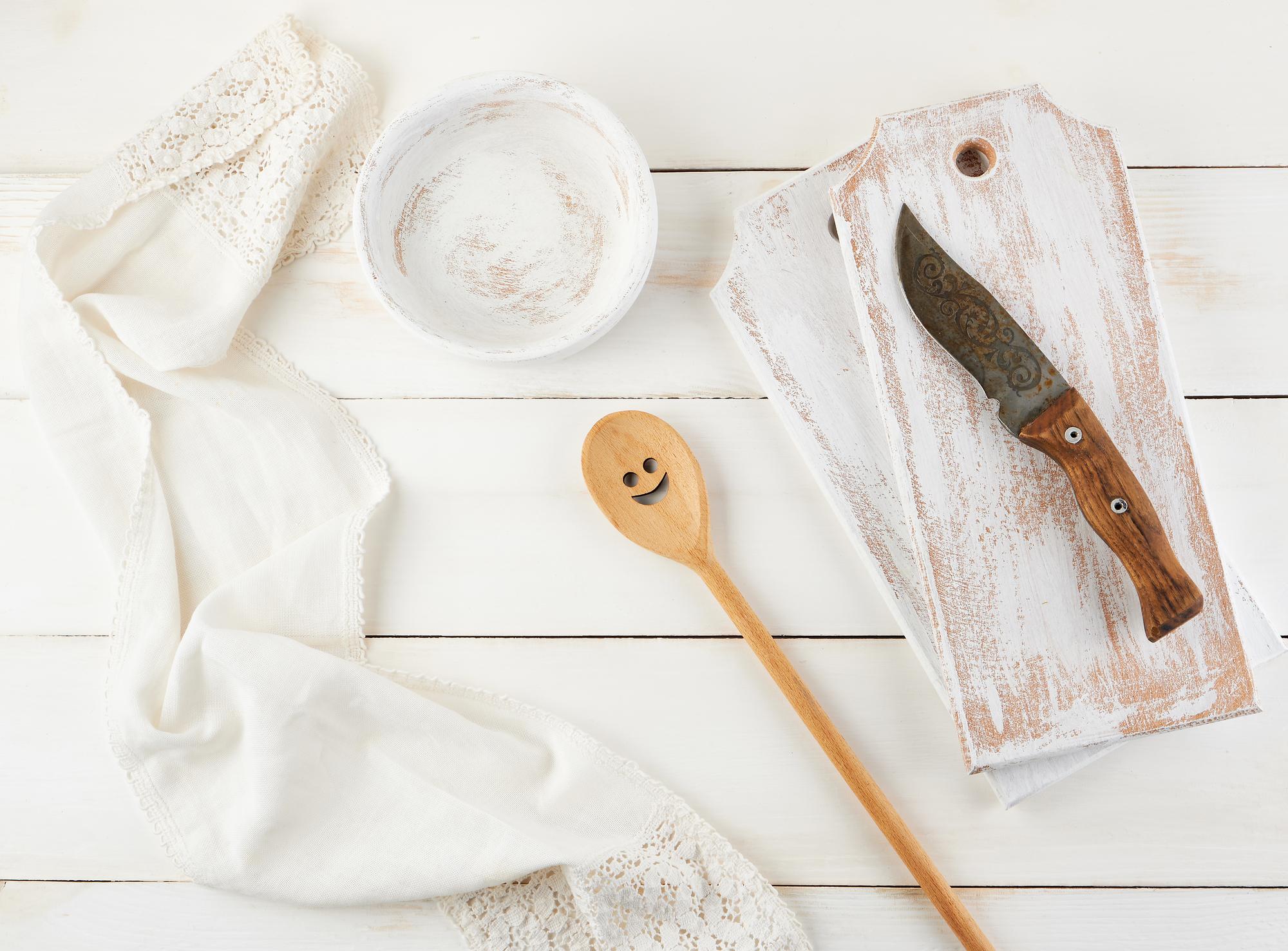 Warm studio kitchen with folded linen and tools